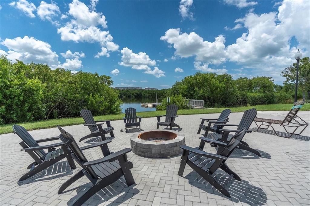 7069 Key Haven Road, Unit 304 Seminole, FL 33777 - Photo 24 of 50 a view of a patio with chairs and table
