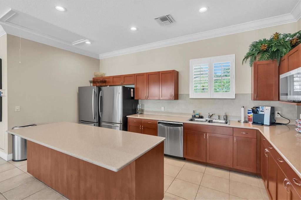7069 Key Haven Road, Unit 304 Seminole, FL 33777 - Photo 35 of 50 a kitchen with stainless steel appliances a sink a counter top space and cabinets
