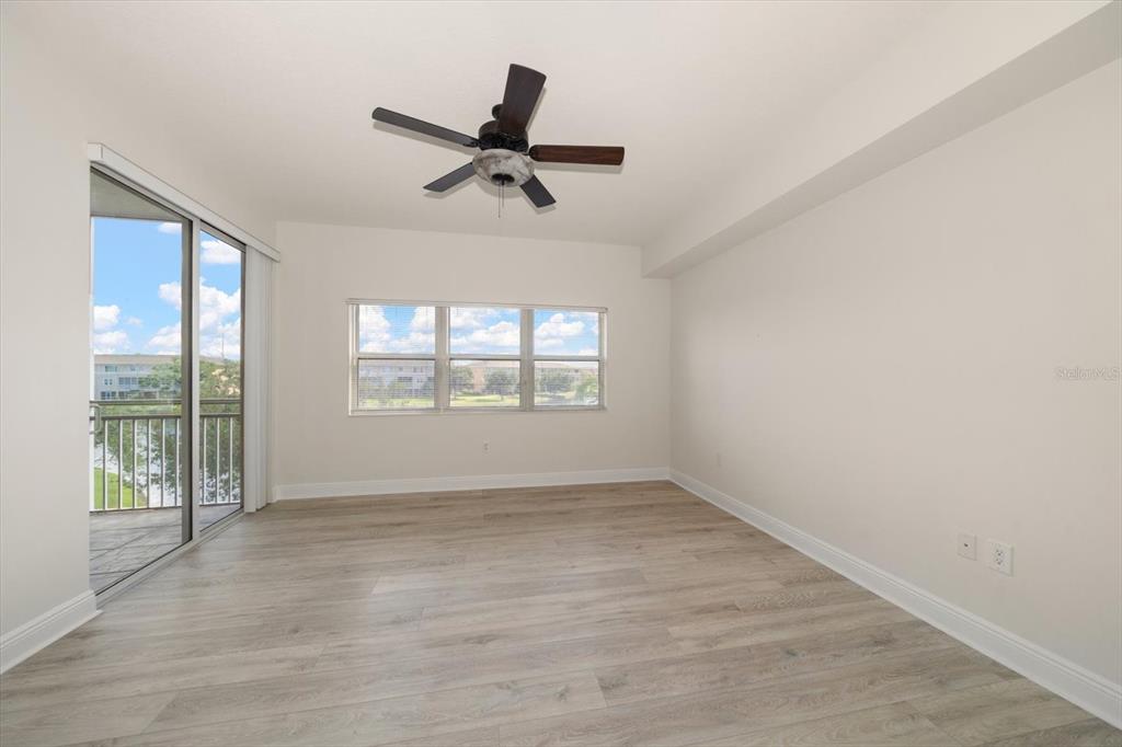 7069 Key Haven Road, Unit 304 Seminole, FL 33777 - Photo 40 of 50 wooden floor in an empty room with a window