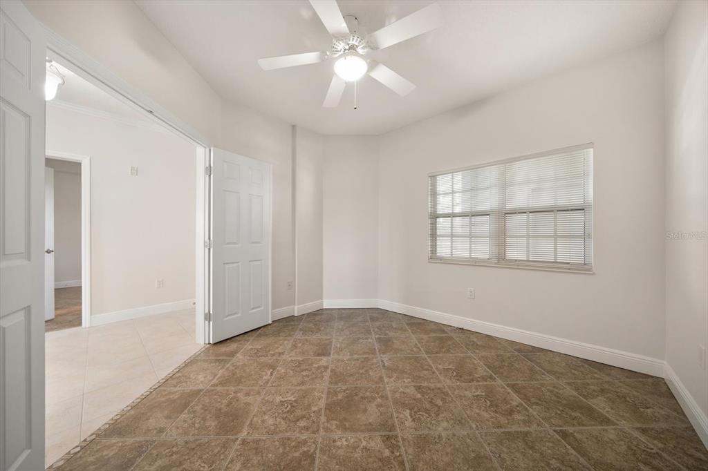 7069 Key Haven Road, Unit 304 Seminole, FL 33777 - Photo 45 of 50 an empty room with windows and fan