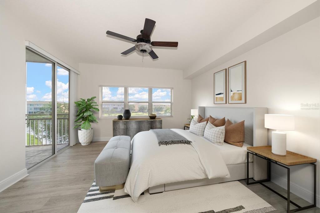 7069 Key Haven Road, Unit 304 Seminole, FL 33777 - Photo 7 of 50 a bedroom with a large bed and a window