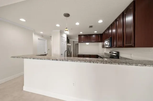 a view of a kitchen with a sink and a refrigerator