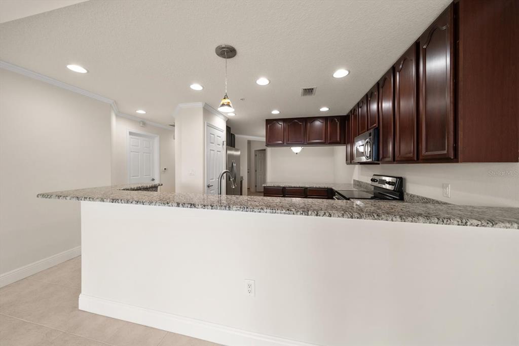 7069 Key Haven Road, Unit 304 Seminole, FL 33777 - Photo 10 of 50 a view of a kitchen with a sink and a refrigerator