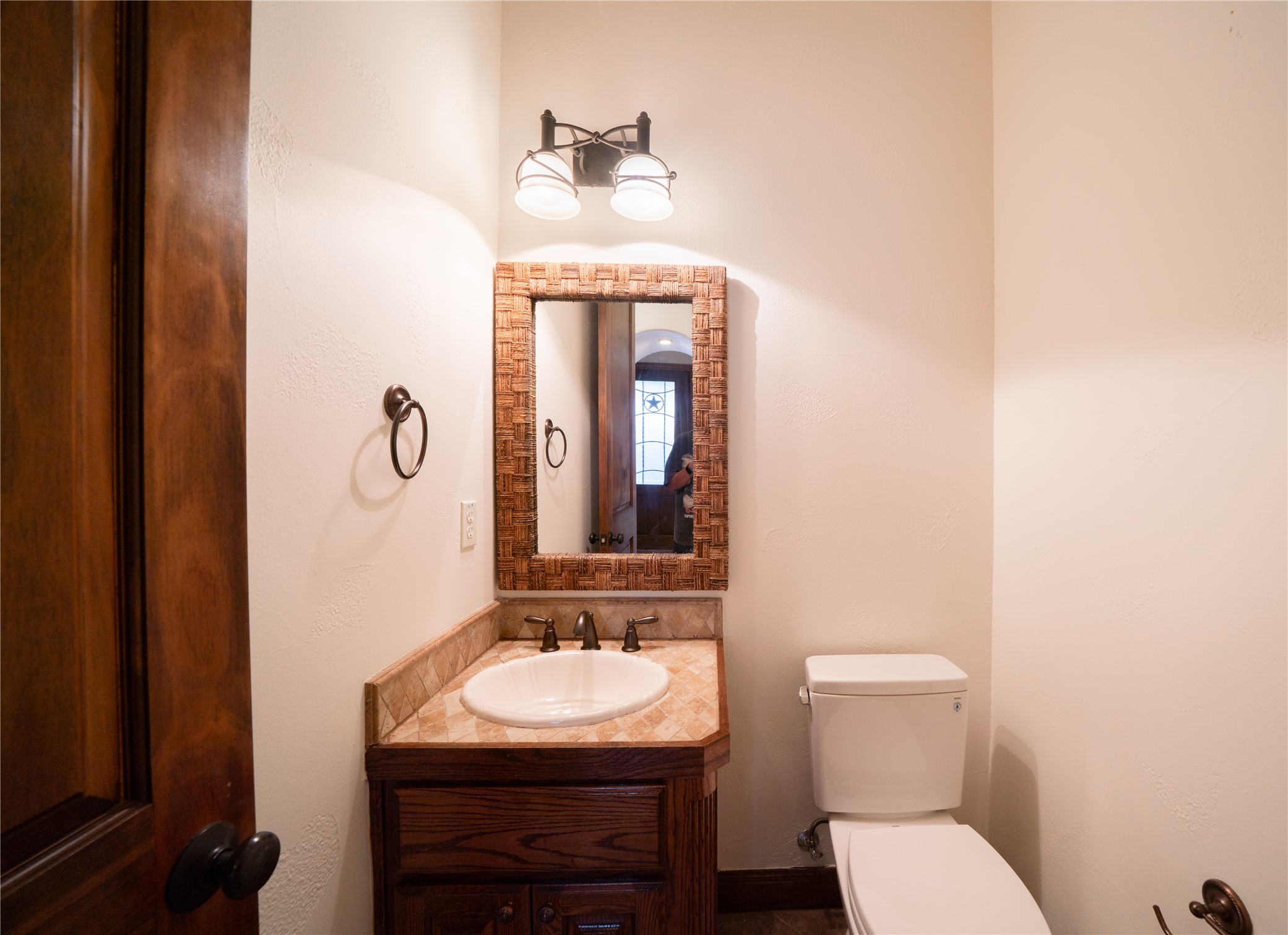 17545 West Reed Park Road, Unit 2 Jonestown, TX 78645 - Photo 16 of 39 a bathroom with a toilet sink and mirror