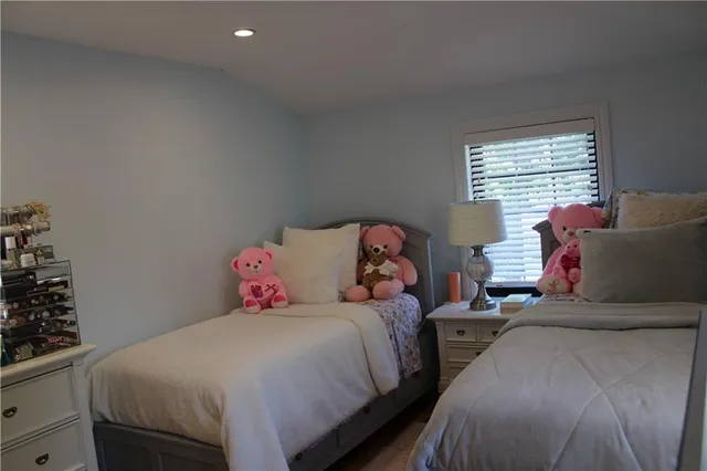 a bedroom with two beds and a window