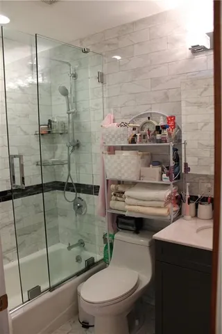 a bathroom with a sink toilet and shower