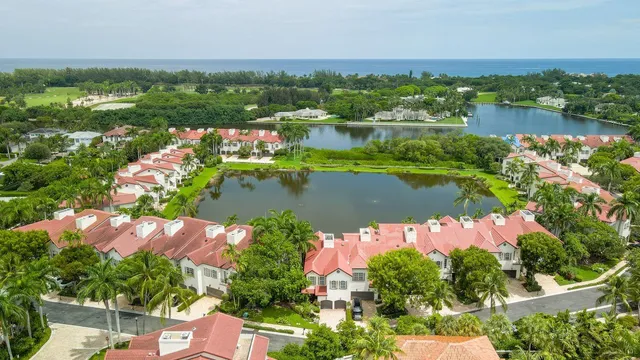 an aerial view of lake residential house with outdoor space and trees all around