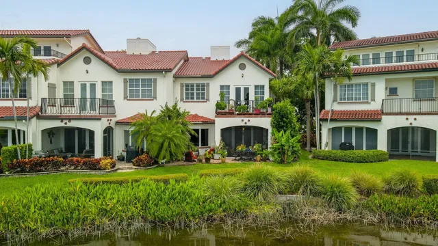 a front view of a residential houses with yard and green space
