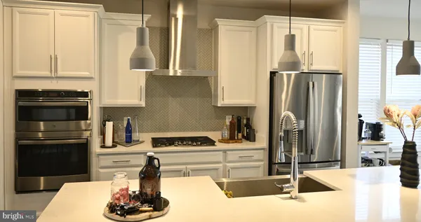 a living room with furniture and a view of kitchen