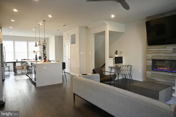 a living room with furniture a rug and white walls
