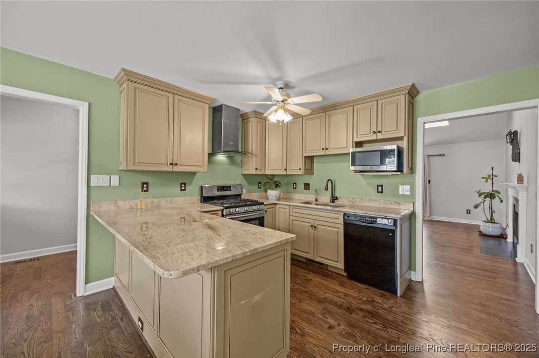 5302 Middleton Road Durham, NC 27713 - Photo 11 of 40 a kitchen with stainless steel appliances granite countertop a kitchen island hardwood floor sink stove and granite counter top