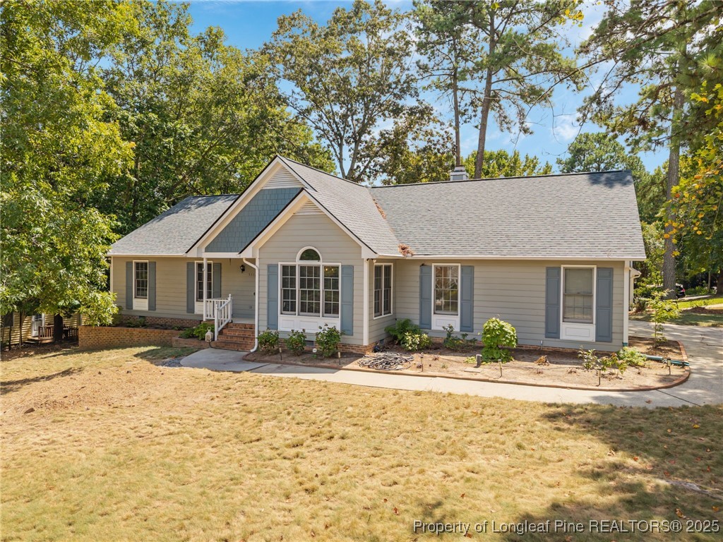 5302 Middleton Road Durham, NC 27713 - Photo 2 of 40 a front view of house with yard outdoor seating and trees in the background