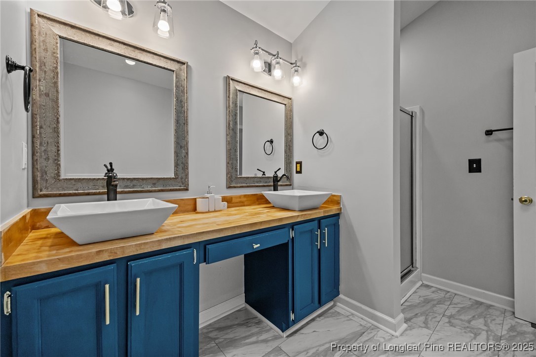 5302 Middleton Road Durham, NC 27713 - Photo 23 of 40 a bathroom with double sink and a mirror