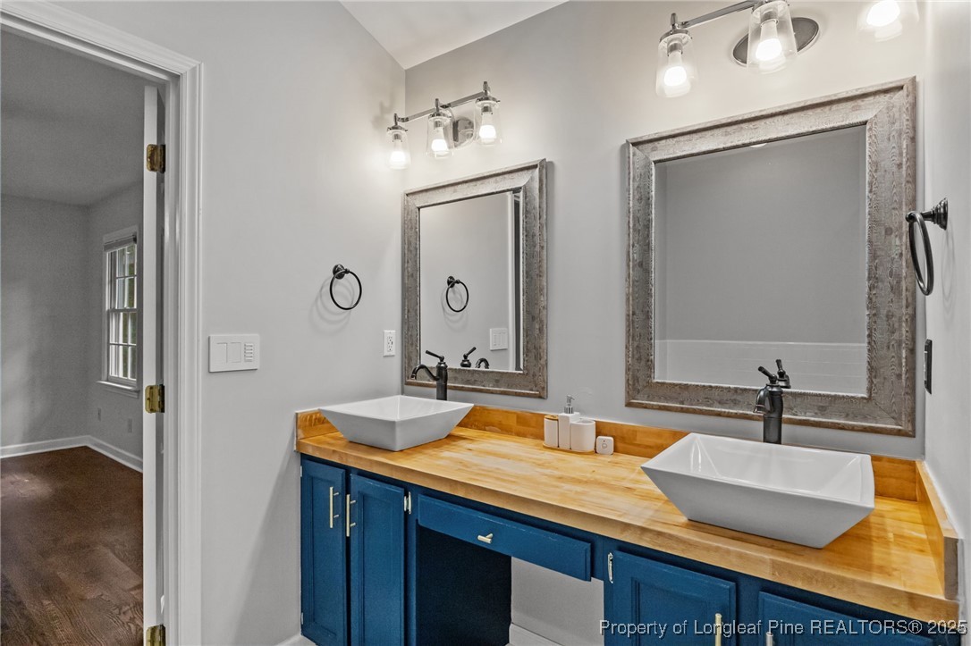 5302 Middleton Road Durham, NC 27713 - Photo 26 of 40 a bathroom with double vanity and a mirror