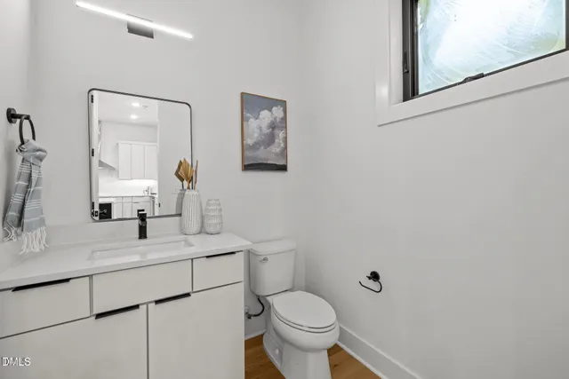 a bathroom with a toilet sink and mirror