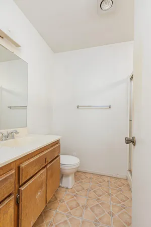 a bathroom with a sink a toilet and a mirror
