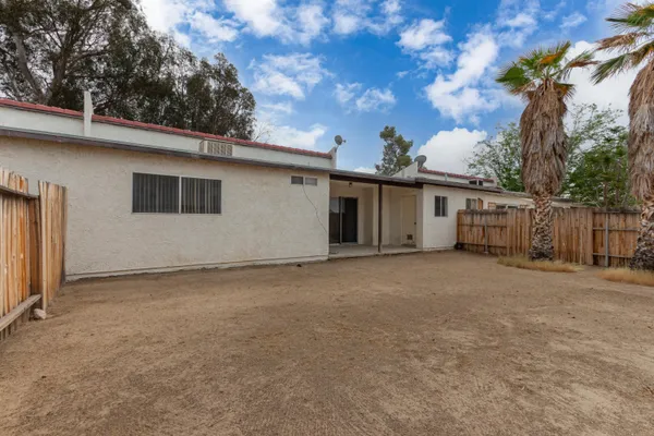 a view of a house with a backyard and garage
