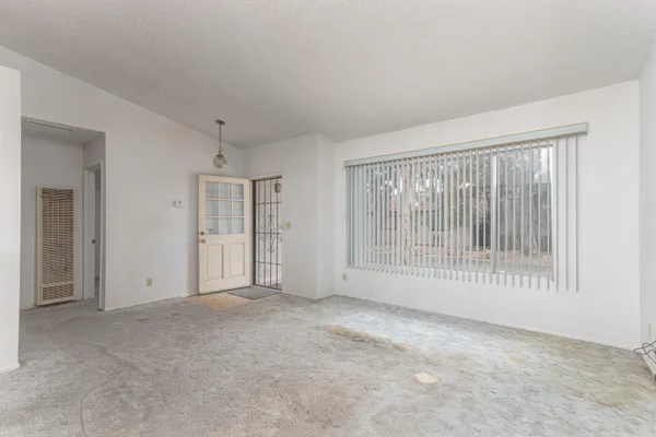 a view of an empty room with glass door