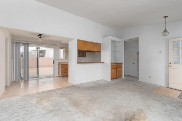an empty room with a cabinet and mirrors