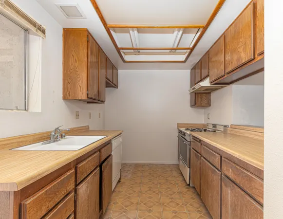 a kitchen with a sink stove and cabinets