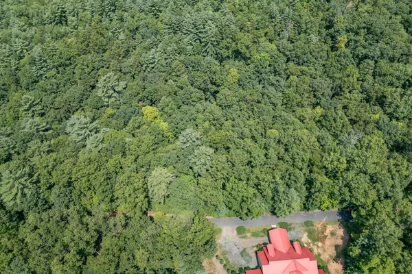 an aerial view of a house with a yard and parking space