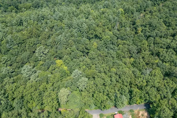 an aerial view of residential house with yard and outdoor seating