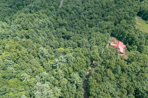 an aerial view of a house with a yard