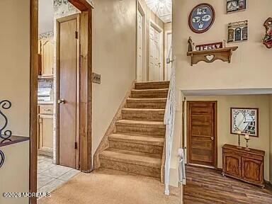 1004 Woodlane Road Jackson, NJ 08527 - Photo 3 of 10 a view of a hallway with entryway wooden floor and front door