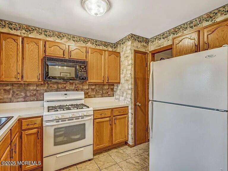 1004 Woodlane Road Jackson, NJ 08527 - Photo 4 of 10 a white refrigerator freezer and a stove top oven