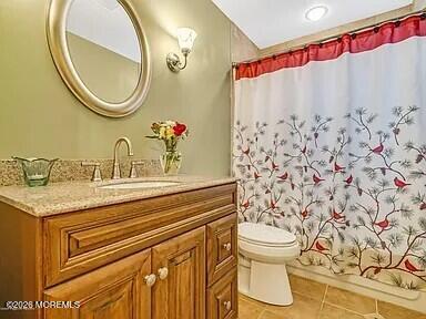 1004 Woodlane Road Jackson, NJ 08527 - Photo 5 of 10 a bathroom with a granite countertop sink and a mirror