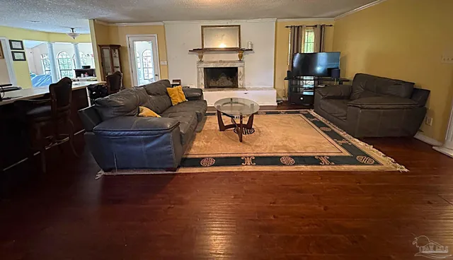 a living room with furniture fireplace and flat screen tv