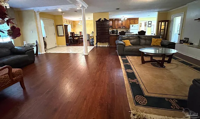 a living room with furniture and a wooden floor