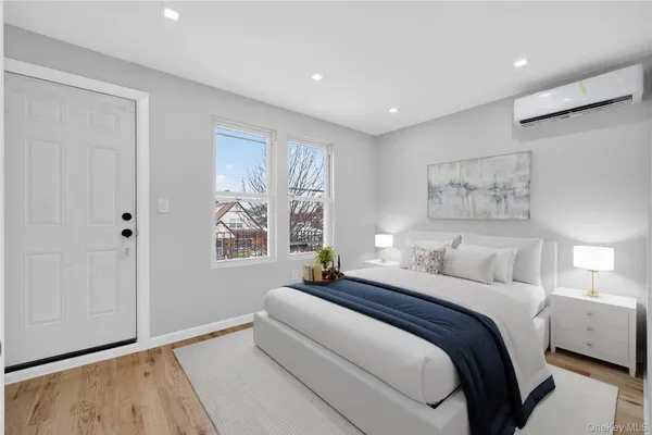 a bedroom with a large bed and a window