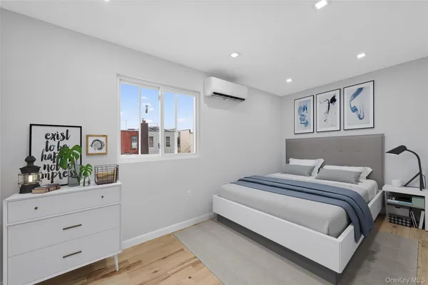 a bedroom with a large bed and paintings on the wall