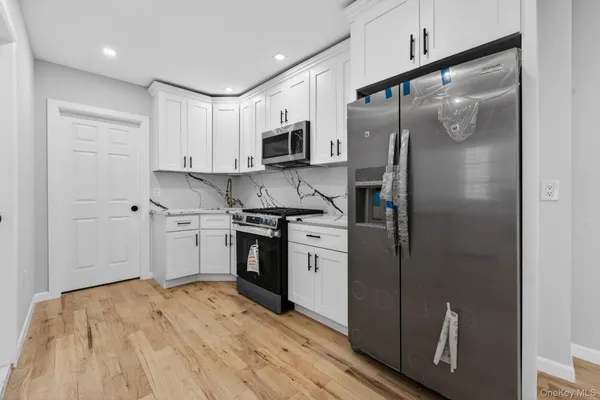 a kitchen with a refrigerator sink and stainless steel appliances