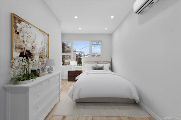 a large white room with a large mirror and sink