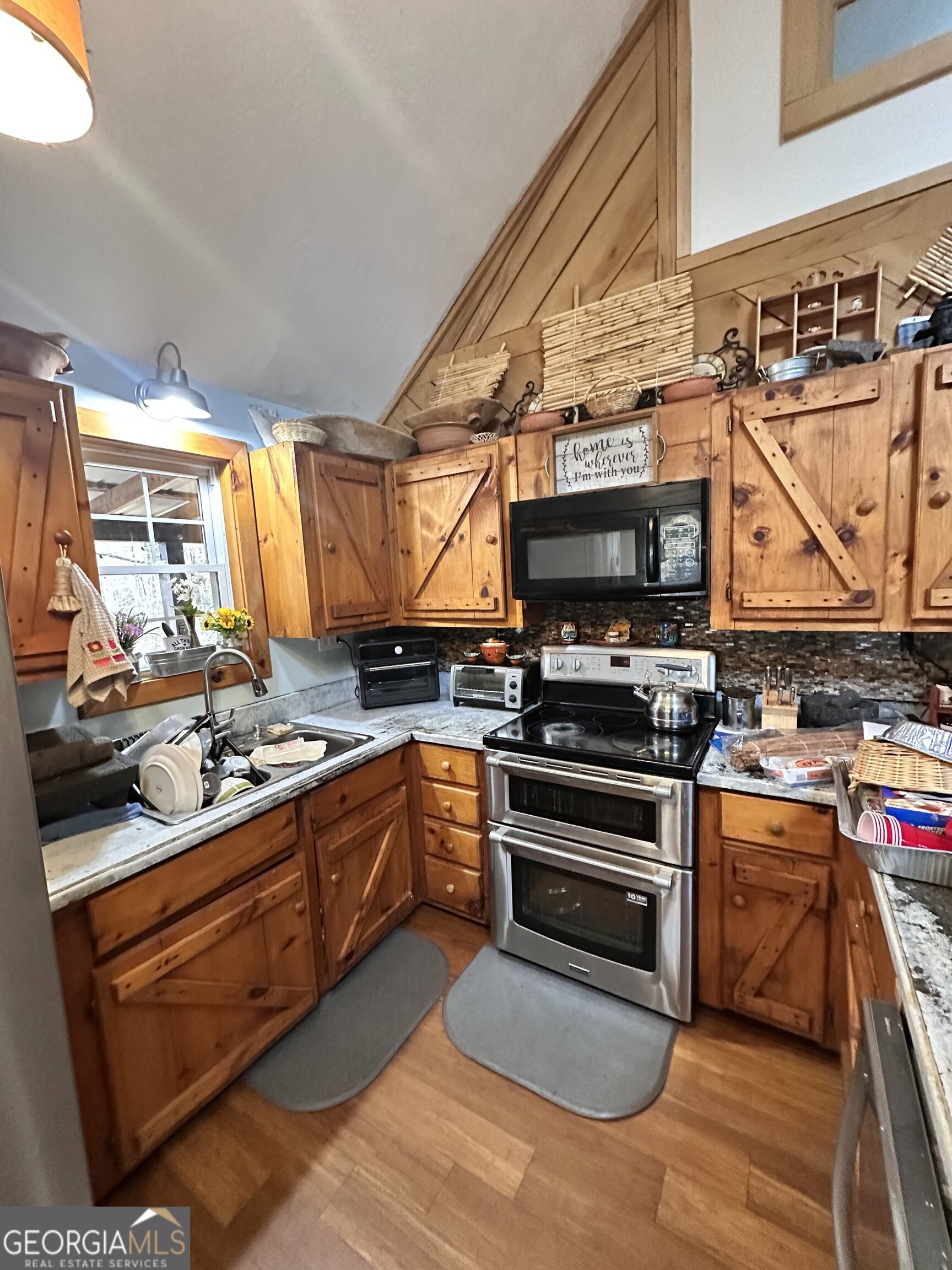 2015 Highway 59 Commerce, GA 30529 - Photo 8 of 27 a kitchen with stainless steel appliances a stove a sink and a microwave