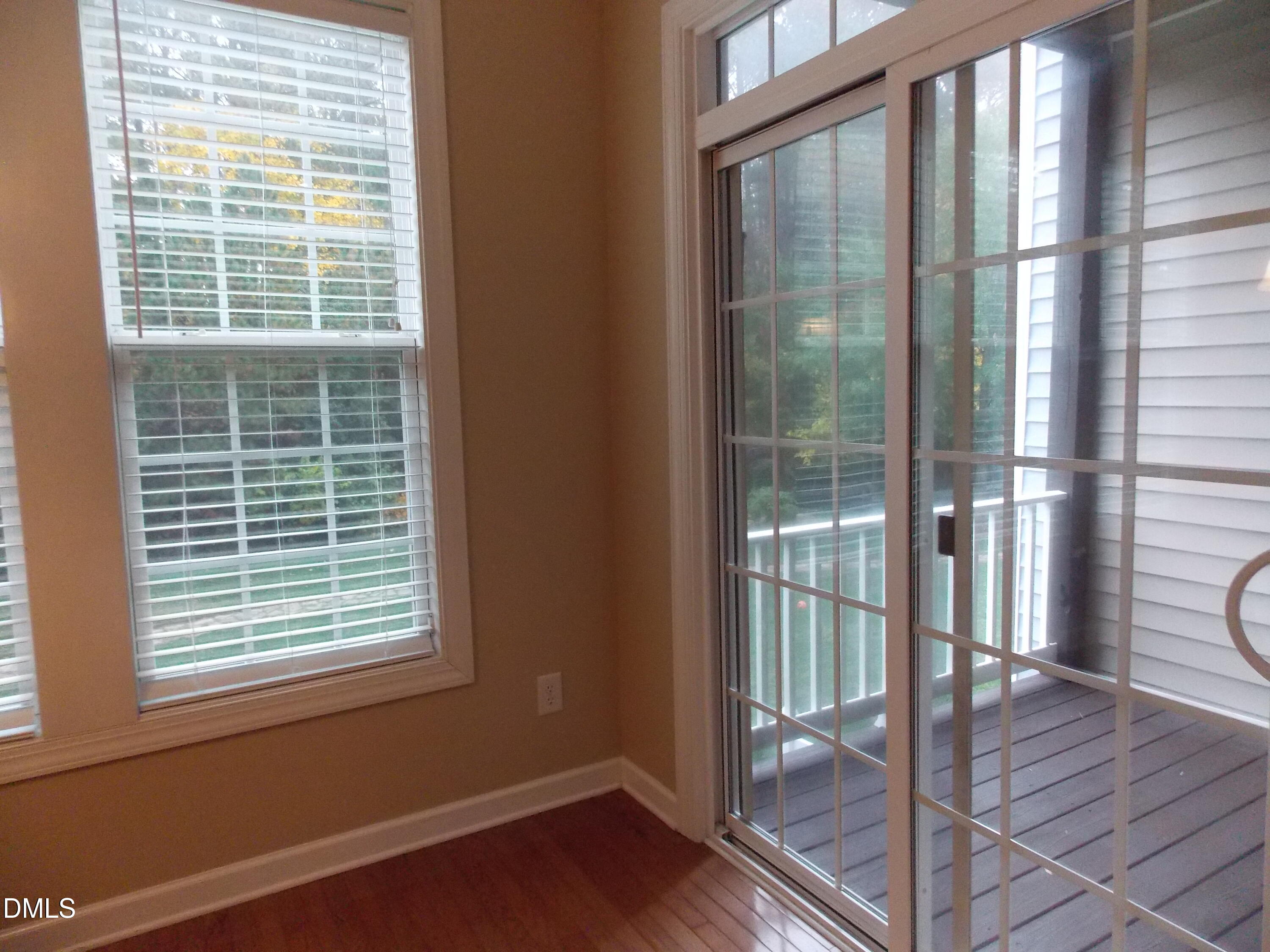 4008 Abbey Park Way Raleigh, NC 27612 - Photo 11 of 28 a view of an empty room with wooden floor and a window