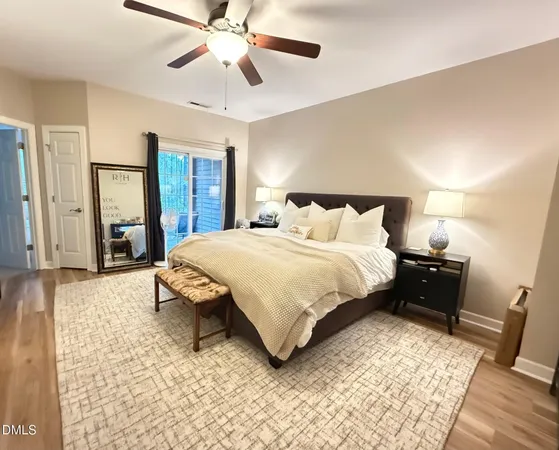 a bedroom with a bed lamps and a chandelier
