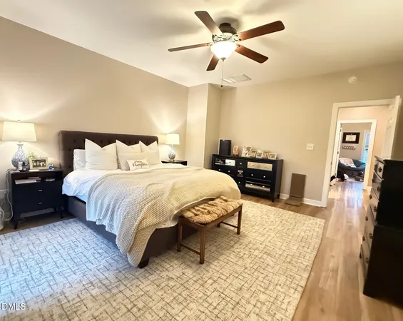 a spacious bedroom with a bed and a chandelier