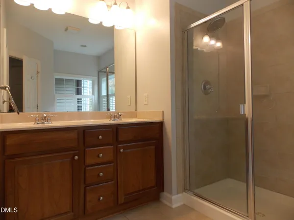 a bathroom with a granite countertop sink mirror and double