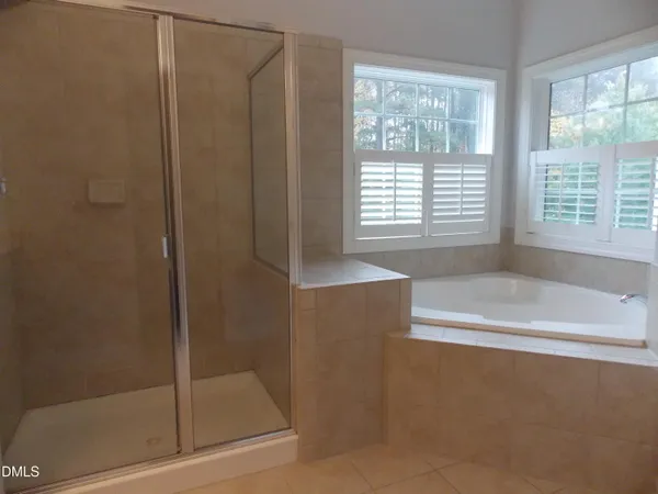 a bathroom with a bathtub and a shower