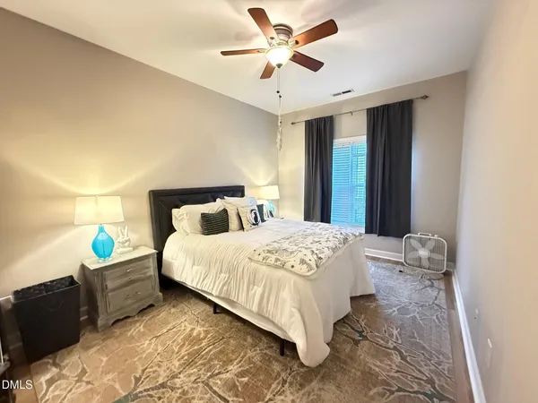 a bedroom with bed and window