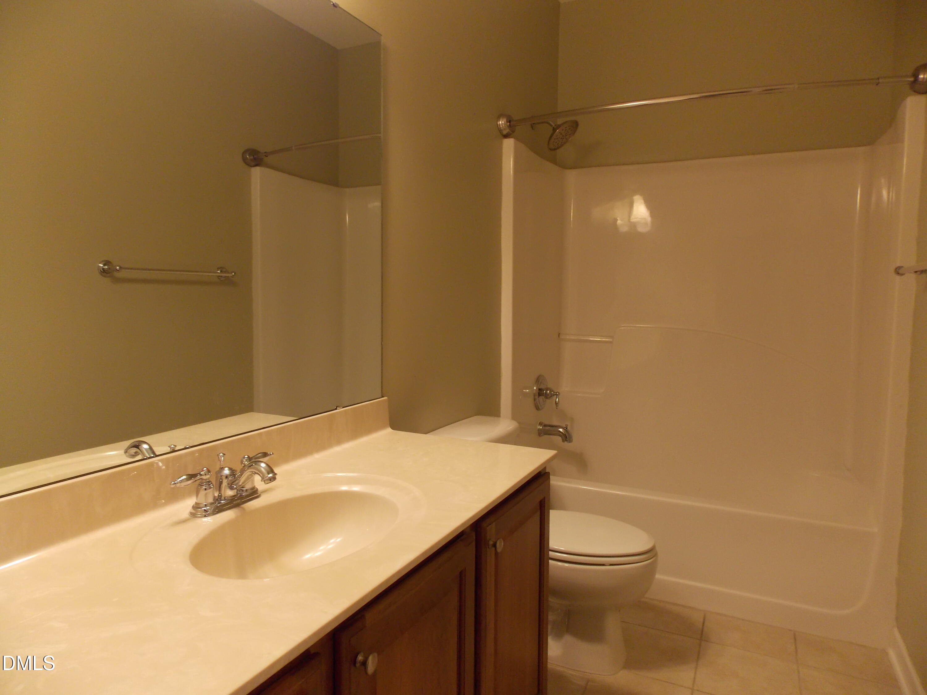4008 Abbey Park Way Raleigh, NC 27612 - Photo 20 of 28 a bathroom with a sink a toilet and shower