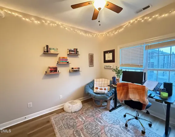 a living room with furniture and a baby crib