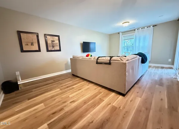 a living room with a bed furniture and a window