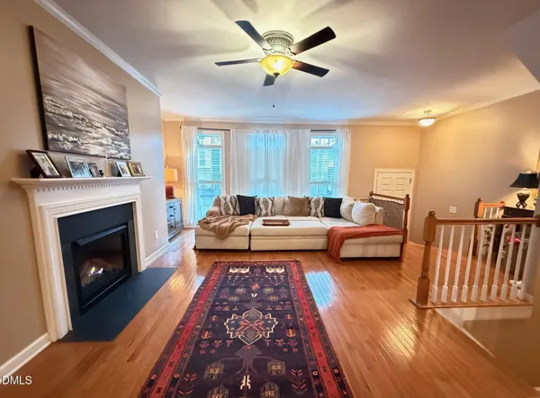 a living room with furniture fireplace and a large window