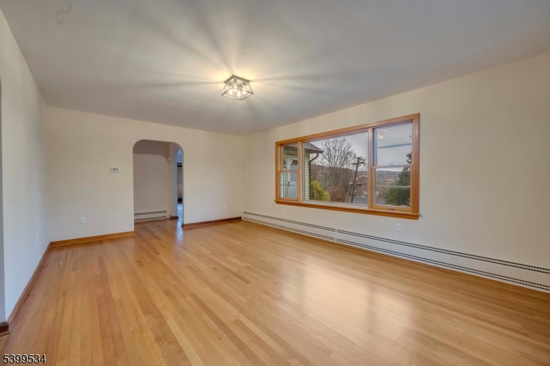 44 Beavers Street High Bridge, NJ 08829 - Photo 13 of 28 a view of an empty room with a window and wooden floor