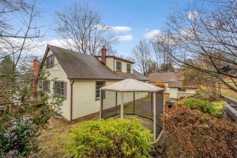 44 Beavers Street High Bridge, NJ 08829 - Photo 9 of 28 a backyard of a house with table and chairs under an umbrella