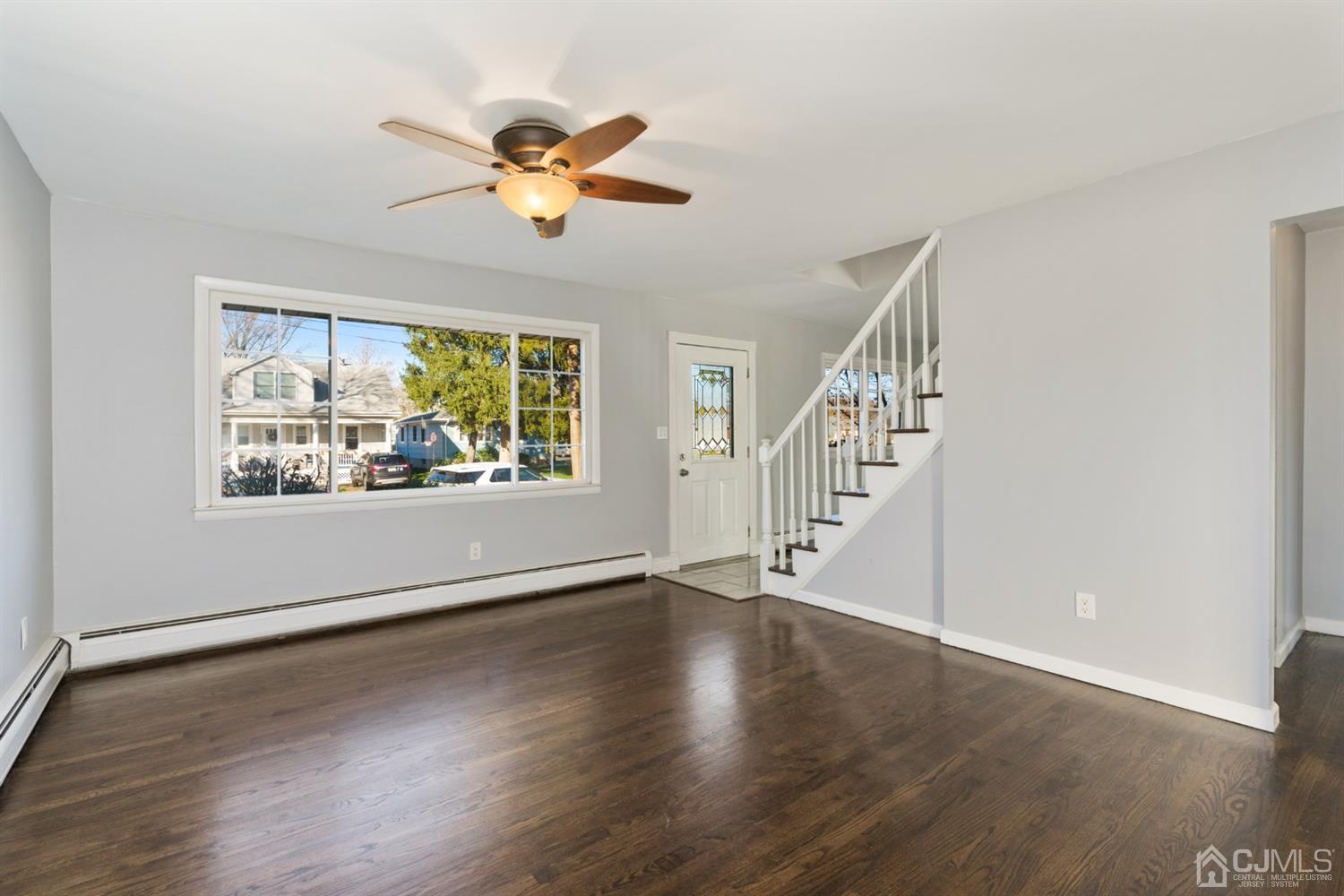 403 Fulton Street Middlesex, NJ 08846 - Photo 2 of 31 a view of an empty room with wooden floor and a window